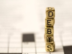 The national credit card debt average has fallen 4 percent in one year, but the numbers are still high.